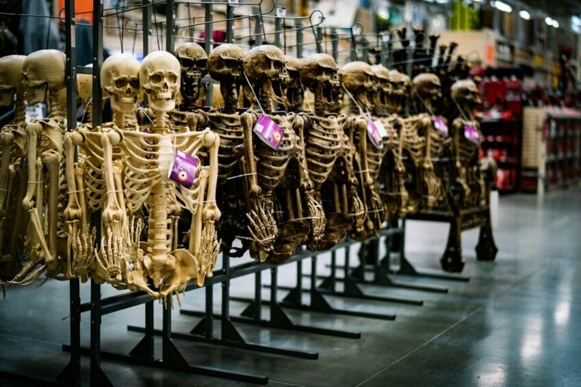 A row of full-body skeleton costumes on display on a store rack, the kind of off-the-shelf Halloween costume sold cheaply online in the Philippines