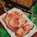 Noche Buena 2026: Pre-Order Ham & Lechon vs. Cooking From Scratch — Which Is Actually Sulit? (Philippines Guide) A whole glazed Christmas ham, sliced and served on a holiday dinner table, the centerpiece buying decision in this Philippine Noche Buena 2026 guide