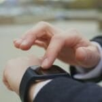 Man checking the touchscreen of a smartwatch on his wrist, illustrating the smartwatch and fitness tracker buying guide for the Philippines