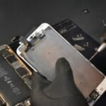 Is AppleCare+ Worth It in the Philippines? (2026 Guide: The Catch for iPhone Owners) Technician repairing an iPhone at a service center — the out-of-warranty repair cost AppleCare+ can't cover in the Philippines since it isn't sold for iPhone